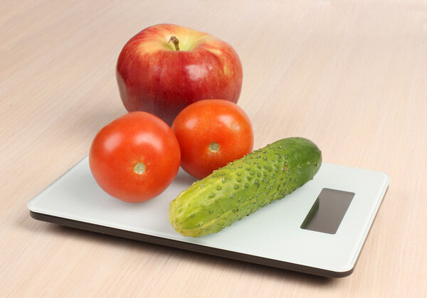 Cucumber and tomatos on scales