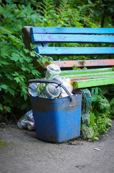 垃圾在公园里靠近长椅的垃圾桶旁边 垃圾可以 塑料废物 — 图库照片