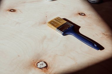 Kenar görünümü, mavi saplı, beyaz, pürüzsüz, zımparalanmış ahşap yüzey ve fotokopi alanı arkaplanı.