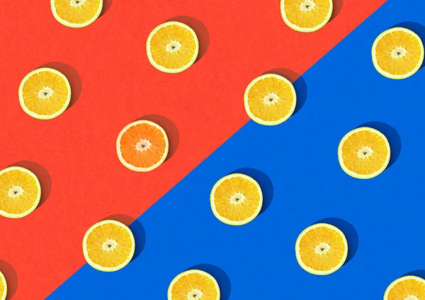 Orange and lemon slices Fruit pattern isolated on red and blue split background. Flat lay, top view tropical fruit trendy background