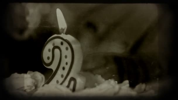 Girl 2 years old blowing out the candles on a birthday cake. Vintage styled shot, 1080p. — Stock Video