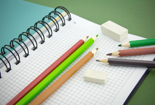Pencil, eraser, notebook Stock Image