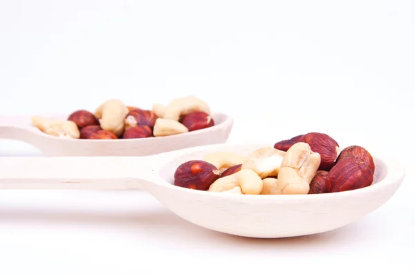 Nuts are in a wooden spoon — Stock Photo, Image