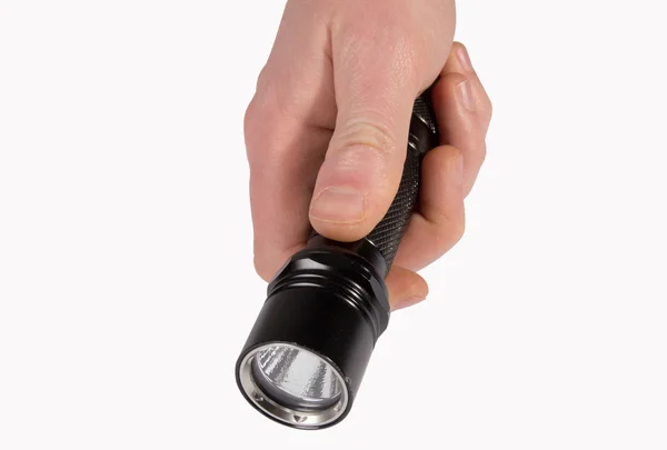 Flashlight in a masculine hand — Stock Photo, Image