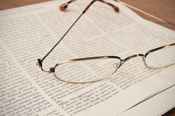 Glasses on a newspaper — Stock Photo, Image