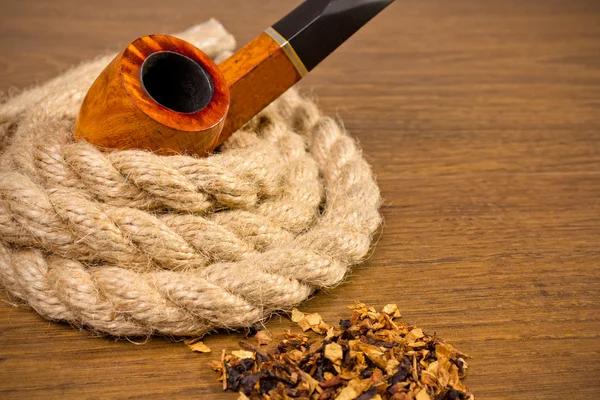 Tobacco-pipe in rope,and tobacco — Stock Photo, Image