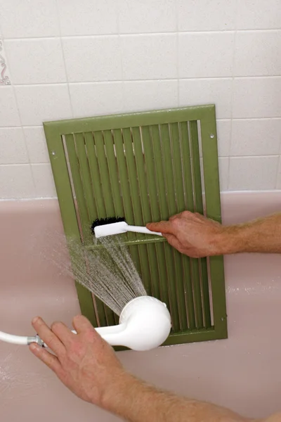 Cleaning an Air Return Vent Royalty Free Stock Photos