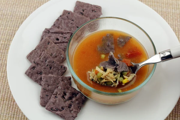Chicken Soup with Purple Crackers — Stock Photo, Image
