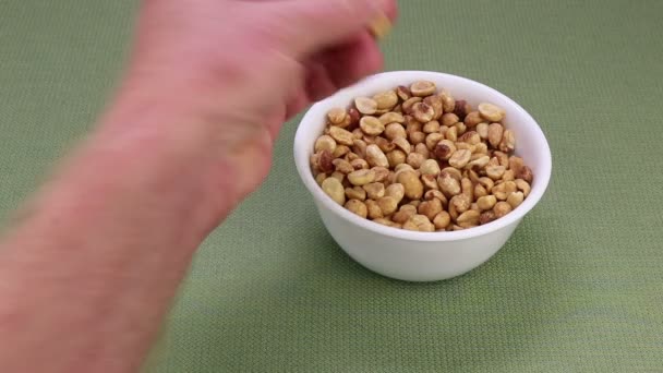 Peanuts Being Picked Out White Bowl Green Table Cloth Eaten — Stock Video