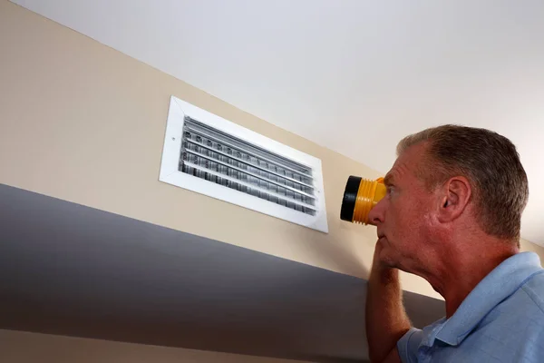 Adult White Man Flashlight Inspecting Rectangle Wall Air Vent Duct — ストック写真