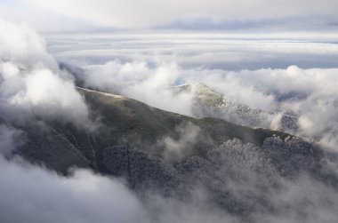 Dramatic clouds with mountain and trees