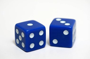 The blue dice on the white background as a gambling