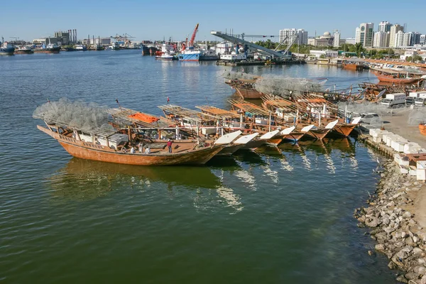 SHARJAH, BAE - 30 Aralık 2004: Birleşik Arap Emirlikleri 'ndeki Sharjah Köprüsü' nün yanında sıralanmış geleneksel gargur ya da balık tuzaklarıyla dolu balıkçı tekneleri.