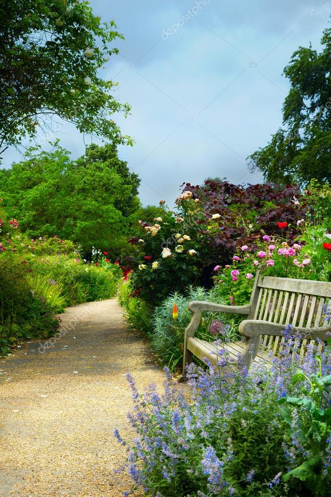 Art Bench And Flowers In The Morning In An English Park Stock