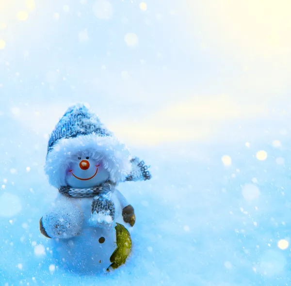 Christmas snowman and blue snow background — Stock Photo, Image