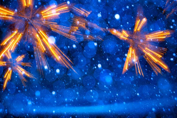 Arte luzes de Natal no fundo azul — Fotografia de Stock