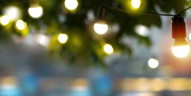 abstract blur background with decoration light in summer italian street caf