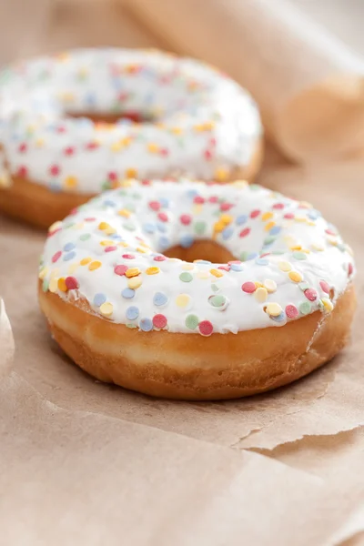 Fresh glazed doughnut with sprinkles — Stock Photo, Image