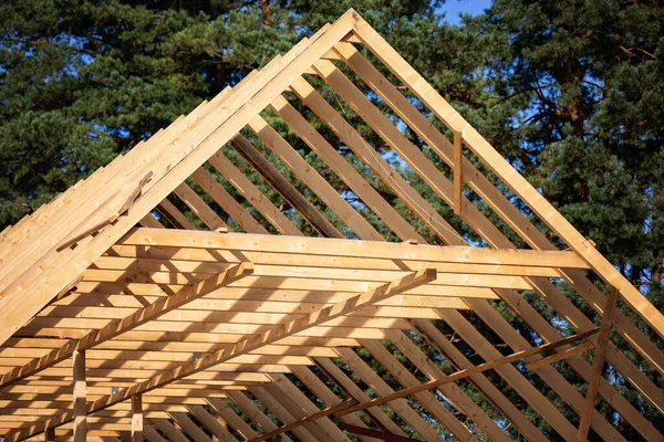 Roofing construction. Wooden roof frame during house construction