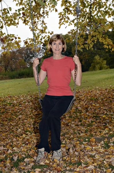 Woman on Swing in Fall — Stock Photo, Image