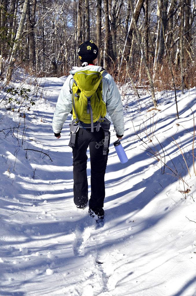 Woman Hiking In Snow