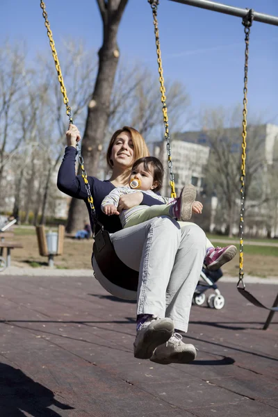 Mother and child on the swing — Stock Photo, Image