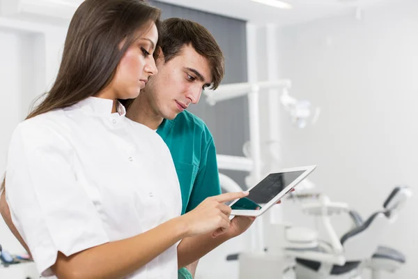 Dentists with tablet — Stock Photo, Image