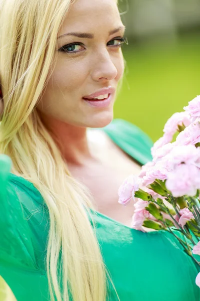 Young blond woman with flowers — Stock Photo, Image