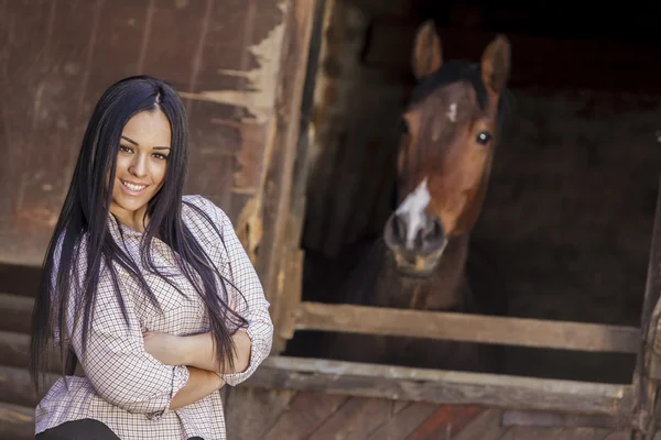 Young woman in the stable — Stock Photo, Image