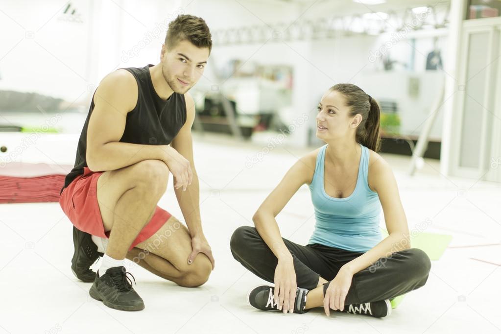 Young man and woman in the gym