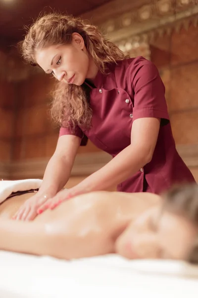 Pretty young woman having a massage — Stock Photo, Image