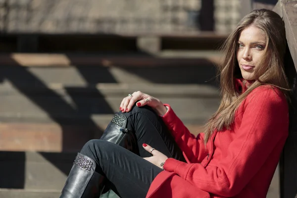 Pretty young woman in red coat — Stock Photo, Image