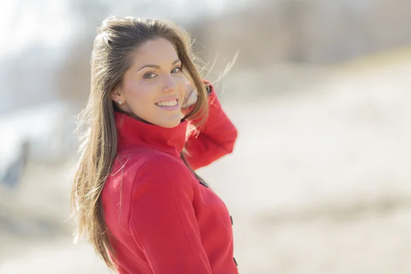 Pretty young woman in red coat Stock Photo