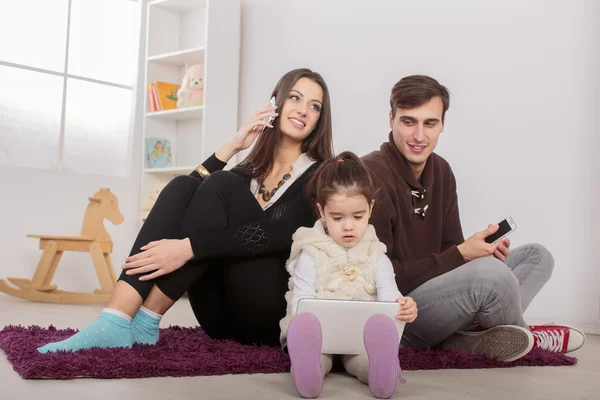 Happy family sitting in the room — Stock Photo, Image