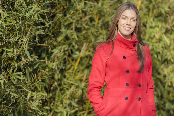 Jolie jeune femme en manteau rouge — Photo