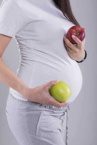 Pregnant woman with apples