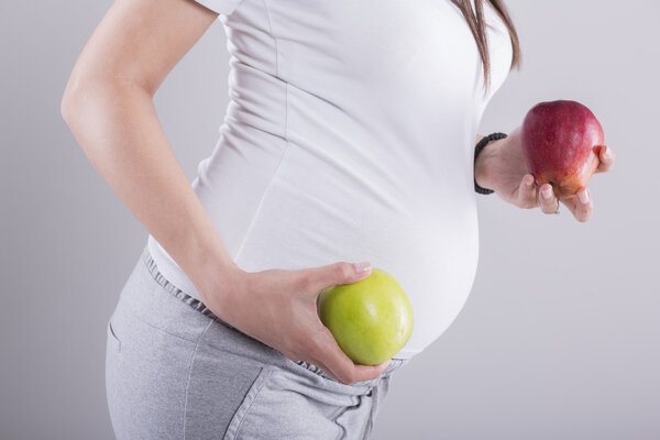 Pregnant woman with apples