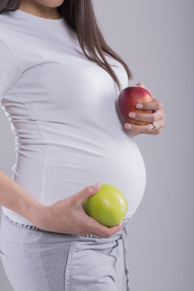Pregnant woman with apples