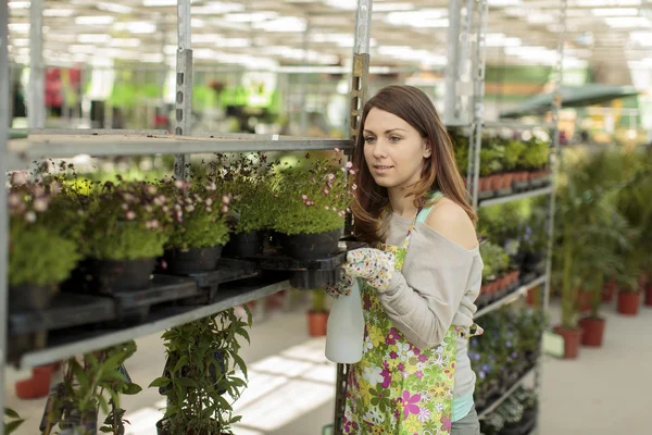 Young woman in flower garden — Stock Photo, Image