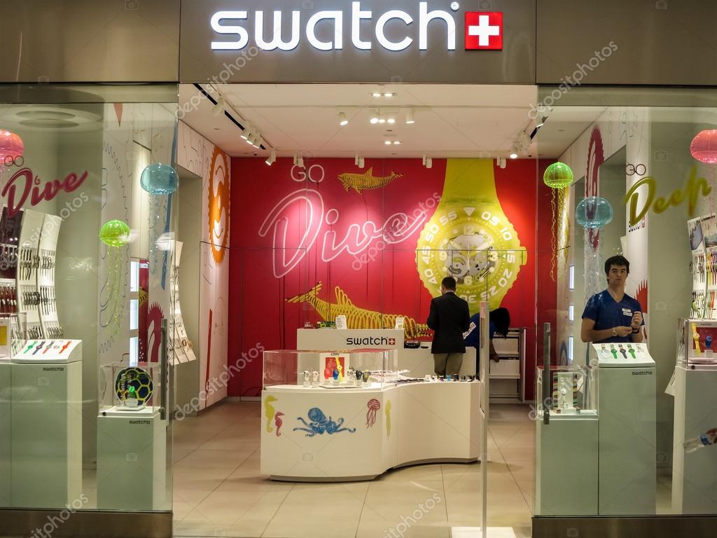 Unidentified people at the Swatch store in Catania. Swatch is watch manufacturing company founded at 1983.