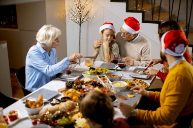 Mutlu çok nesilli aile yeni yılı evde, masada kutluyor.