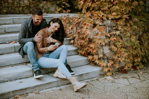 Handsome Young Couple Sitting Outdoor Stairs Autumn Day Using Mobile — Stock Photo, Image