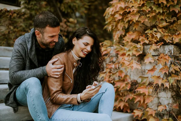 Handsome Young Couple Sitting Outdoor Stairs Autumn Day Using Mobile — Stock Photo, Image