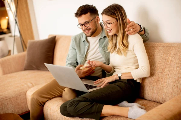 Handsome Young Couple Using Laptop Together While Sitting Sofa Home — Stock Photo, Image