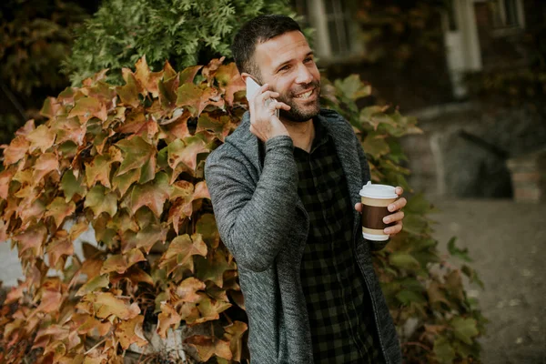 Handsome Young Man Using Mobile Phone Holding Takeaway Coffee Park — Stock Photo, Image