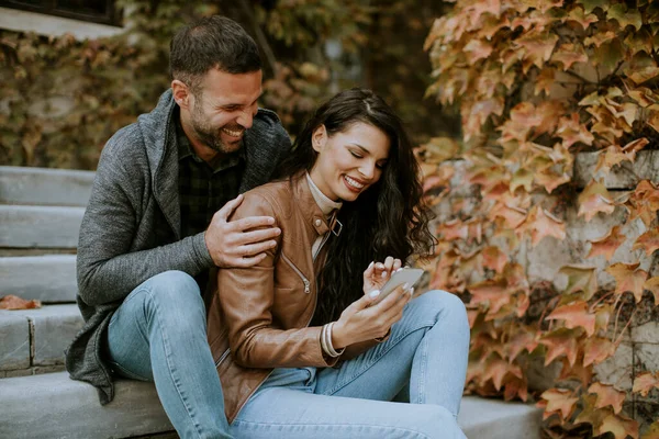 Handsome Young Couple Sitting Outdoor Stairs Autumn Day Using Mobile — Stock Photo, Image