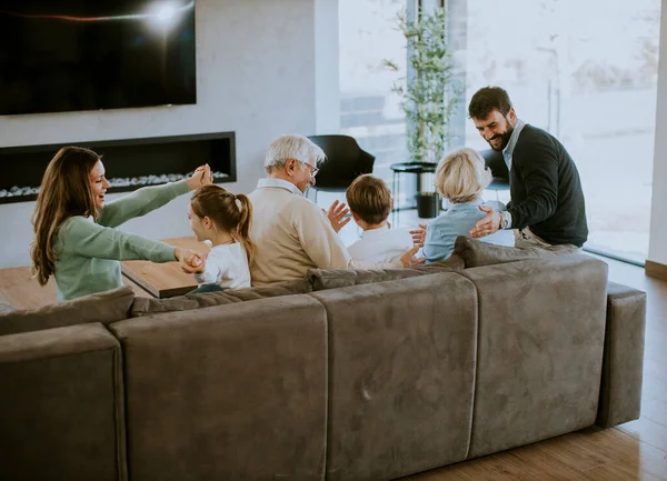 Multi Generation Family Sitting Together Sofa Modern Apartment Watching — Stock Photo, Image