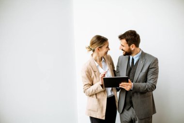 Modern ofisin duvarında dijital tabletli gençler