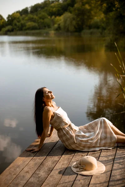 Young Woman Relaxing Wooden Pier Calm Lake Hot Summer Day — Stockfoto