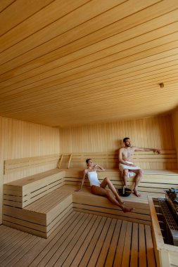 Saunada dinlenen yakışıklı genç çift.